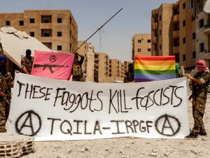 "These Faggots Kill Fascists! We shoot back! The Black & Pink and Rainbow flag fly in Raqqa. #Queers smashing the Caliphate" this photo was captioned on Twitter (IRPGF)