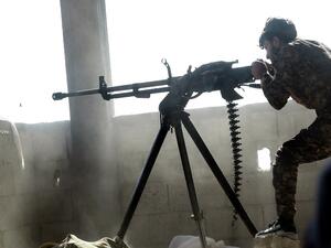 A member of the Kurdish People's Protection Units (YPG) fires a machine gun in the Syrian city of Raqa's eastern al-Sinaa district, on June 21, 2017, during an offensive by US-backed fighters to retake the Islamic State (IS) group bastion. (Delil Souleiman/AFP)