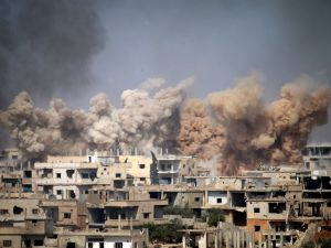 Smoke rises from buildings following a reported air strike on a rebel-held area in the southern Syrian city of Daraa, on June 14, 2017. (Mohamad Abazeed/AFP)