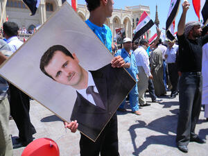 Supporters of Assad gather in 2010 (Flickr, image used for illustrative purposes only)