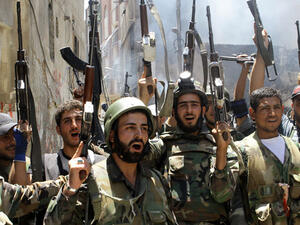 Syrian army soldiers celebrate outside of Damascus. (AFP/File)