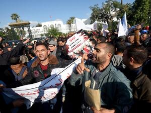 Tunisian unemployed people shout slogans during a demonstration against the government's policy on December 10, 2016 outside the Assembly of the Representatives of the People in Tunis, as the draft budget for 2017 is being reviewed by parliament. (AFP/Fethi Belaid)