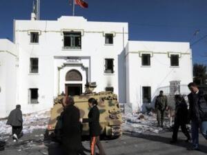 People walk past a government building in Kef, Tunisia. (AFP/File)