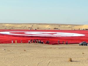 The flag is the size of 19 football pitches.(AFP Photo/Saif Trabelsi)