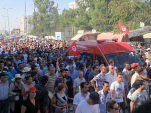 TUNISIA, Tunis : An ambulance, carrying the body of Tunisian opposition politician Mohamed Brahmi, drives to the Charles Nicile Hospital in Tunis before an autopsy after Brahmi was gunned down in front of his home on July 25, 2013. AFP PHOTO / FETHI BELAID