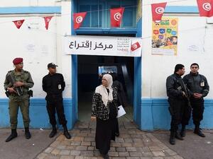 A Tunisian woman exits a Tunis polling station after voting in the first round of presidential elections on November 23, 2014. (AFP/File)