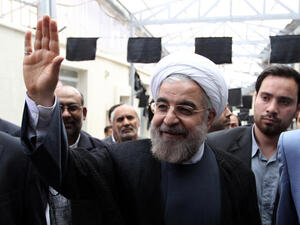 Hassan Rowhani, a moderate Iranian presidential candidate and former top nuclear negotiator, waves as he arrives for to campaign at the Jamaran mosque in Tehran (Atta Kanare/ AFP)