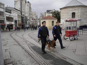Turkish police patrol with a police dog a day after a suicide bomb attack on Istiklal Street, a major shopping and tourist district, in central Istanbul, on March 20, 2016. (AFP/Yasin Akgul)