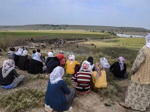 Women look at a huge crater after a powerful blast on May 13, 2016 in the area of Sarikamis on the outskirts of the majority Kurdish city of Diyarbakir. (AFP/Ilyas Akengin)