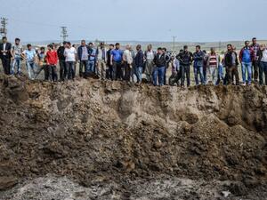 People look in a huge crater after a powerful blast on May 13, 2016 in the area of Sarikamis on the outskirts of the majority Kurdish city of Diyarbakir. (AFP/Ilyas Akengin)