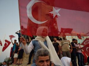 A child waves a Turkish flag in Istanbul on July 16, 2016 during a demonstration in support to Turkish president. (AFP/Daniel Mihailescieu