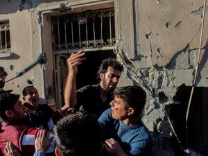 Relatives of injured people react at the site after a rocket hit a house on May 5, 2016 in Kilis. (AFP/Stringer)