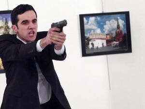 Photographer Burhan Ozbilici kept his cool and continued photographing as the ambassador was murdered, while others dove for cover. (Twitter/AP/Burhan Ozbilici)