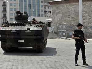 A police officer stands next to an armored vehicle that was used by soldiers during the coup attempt at Taksim square in Istanbul on July 17, 2016. (AFP/Aris Messinis)