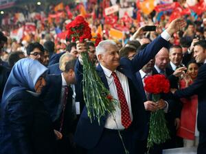 Turkey's Minister of Transport, Maritime and Communication and new chairman candidate for ruling AK Party Binali Yildirim greets supporters as he arrives with his wife Semiha Yildirim for the second extraordinary congress of the AK Party in Ankara, on May 22, 2016. (AFP/Adem Altan)
