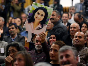 A supporter holds a portrait of Figen Yuksekdag, the detained co-leader of Turkey's pro-Kurdish opposition Peoples' Democratic Party, during a meeting at the Turkish parliament in Ankara, Nov. 8, 2016. (AFP/File)