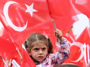 Supporters cheer Turkey's President Recep Tayyip Erdogan as he addresses an election rally in the Golbasi district of Ankara. (AFP PHOTO/ADEM ALTAN)