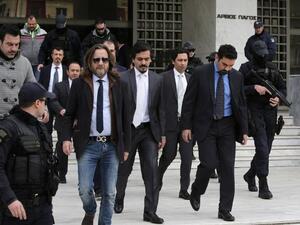 Turkish officers are escorted by Greek special police forces as they leave the Greek Supreme Court in Athens, after a hearing concerning a possible extradition of the officers over July's failed coup in Turkey, on January 23, 2017 in Athens. (AFP/Angelos Tzortzinis)