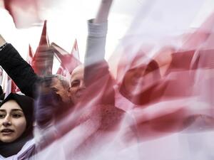 People wave "YES" banners and Turkish national flags on April 8, 2017 during a campaign rally for the "yes" vote in a constitutional referendum in Istanbul. (AFP/Bulent Kilic)