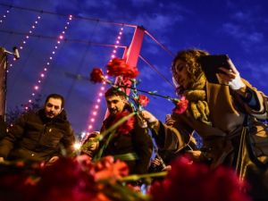People lay flowers Tuesday in front of a memorial at the Reina nightclub, scene of Istanbul's deadly New Year's attack. (AFP/Yasin Akgul) 