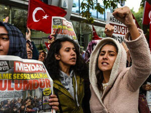 Turkish protesters shout slogans outside the headquarters of Bugun newspaper and Kanalturk television station in Istanbul. (AFP)