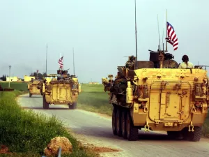 US forces, accompanied by Kurdish People's Protection Units (YPG) fighters, drive their armoured vehicles near the northern Syrian village of Darbasiyah. (AFP/File)