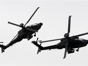 Helicopters of the UAE armed forces fly during a military show at the opening of the International Defense Exhibition and Conference (IDEX) at the Abu Dhabi National Exhibition Centre in the Emirati capital on February 22, 2015. (AFP)