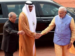 The Crown Prince of Abu Dhabi General Sheikh Mohammed Bin Zayed Al Nahyan (C) is met by Indian Prime Minister Narendra Modi (R) and Indian President Pranab Mukherjee (L) in New Delhi January 25, 2017. (AFP/Money Sharma)