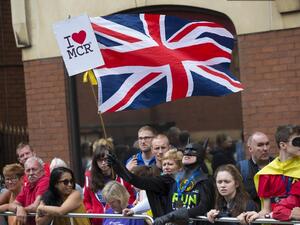 A man dressed as Batman waves a Union flag at the start of the Great Manchester Run in Manchester, north west England on May 28, 2017. (Jon Super/AFP)