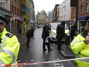 Police officers work on Borough High Street, close to Borough Market, in London on June 6, 2017, as the police investigations continue following the June 3 terror attack. (Odd Andersen/AFP)