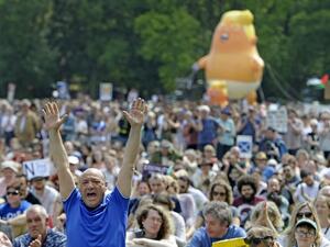 A giant balloon depicting US President Donald Trump as an orange baby is launched as protesters gather in the Meadows, after taking part in the Scotland United Against Trump march through the streets of Edinburgh, Scotland on July 14, 2018, on the third day of US President Donald Trump's four-day UK visit. (AFP/File)