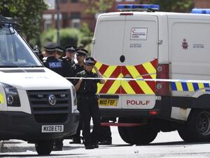 Police officers work at the scene near a property they entered in the Moss Side area of Manchester on May 27, 2017 during an operation relating to last week's terror attack in the city. (Oli Scarff/AFP)