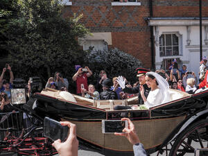 Prince Harry, Duke of Sussex and Meghan Markle, Duchess of Sussex leave Windsor Castle in Ascot Landau carriage during a procession after getting married at St Georges. (Shutterstock)
