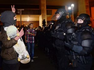 A protestor gestures at police at Pioneer Square in Portland, Oregon on November 11, 2016, to protest the election of US President-elect Donald Trump. (AFP/Ankur Dholakia)