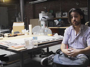 Ramsey Nasser with one of his calligraphy pieces created by Alb, an Arabic computer programming language he designed. (YouTube/Animal New York)