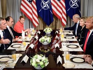 NATO Secretary General Jens Stoltenberg (L) and US President Donald Trump (R) and staff speak at a breakfast meeting at the US chief of mission's residence in Brussels on July 11, 2018, ahead of a NATO summit. (Brendan Smialowski/ AFP)
