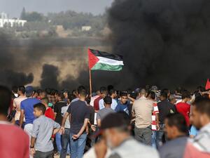 Palestinian protesters wave their national flag as they gather during a demonstration at the Israel-Gaza border, east of Khan Yunis in the southern Gaza Strip on August 10, 2018. (Said KHATIB / AFP)