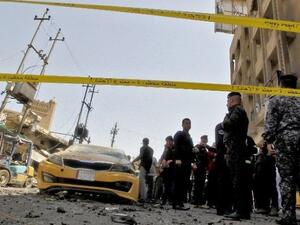 Iraqis gather at the site of a car bomb explosion near Baghdad's Al-Shuhada Bridge. (AFP/Sabah Arar)
