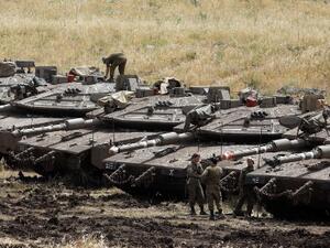 Israeli Merkava tanks are seen in a deployment area near the Syrian border in the Israel-annexed Golan Heights on May 10, 2018 (AFP)