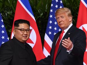 US President Donald Trump meets with North Korea's leader Kim Jong-un at the start of their historic US-North Korea summit. (Saul Loeb/AFP)