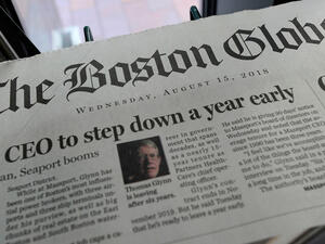 Copies of the Boston Globe are seen at a newspaper stand. (AFP/ File)
