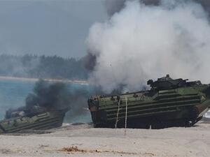 Amphibious Assault Vehicles (AAV) of the US marines emit white smoke during an amphibious landing exercise at the beach of the Philippine. (AFP/File)