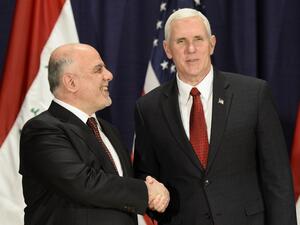 This file photo taken on February 18, 2017 shows US Vice President Michael Richard Pence (R) and Iraq's Prime Minister Haider Al-Abadi as they shake hands in Munich, southern Germany. (AFP/Thomas Kienzle)