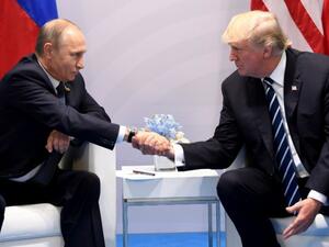 US President Donald Trump and Russia's President Vladimir Putin shake hands during a meeting on the sidelines of the G20 Summit in Hamburg, Germany, on July 7, 2017. (AFP/ Saul Loeb)