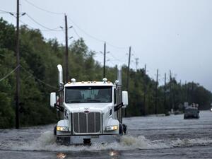 A driver on an Oregon road captured video of a semi truck that somehow lost two wheels on a city road. (AFP/ File Photo)