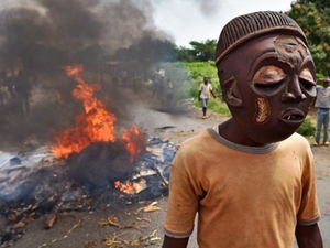 A protester wears a mask in a demonstration against Pierre Nkurunziza in 2015 (AFP/FILE)