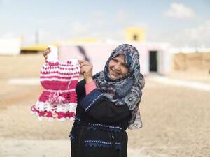 An Azraq camp resident stands in front of a newly-opened centre for women (Photo courtesy of the Danish Refugee Council)