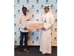Chandra Sekhar Gembal, winner of the KD4,000 draw, receiving his cheque. 