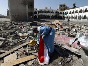 A man walks through the rubble of a school after an airstrike in Sanaa, Yemen, in February. (AFP/Muhammed Huwais)