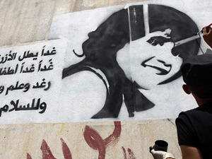 A Yemeni man paints the face of a child on a wall in the capital Sanaa, to raise awareness about the death and exploitation of children in war. The writing in Arabic is part of the lyrics of a Lebanese song about children.  (AFP/File)